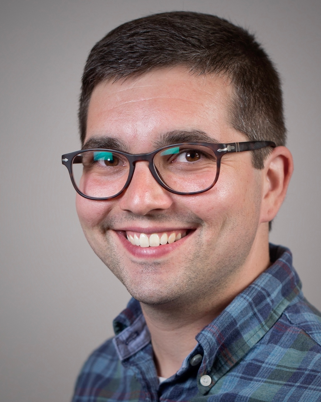 A picture of Eric Hall in a blue plaid shirt.